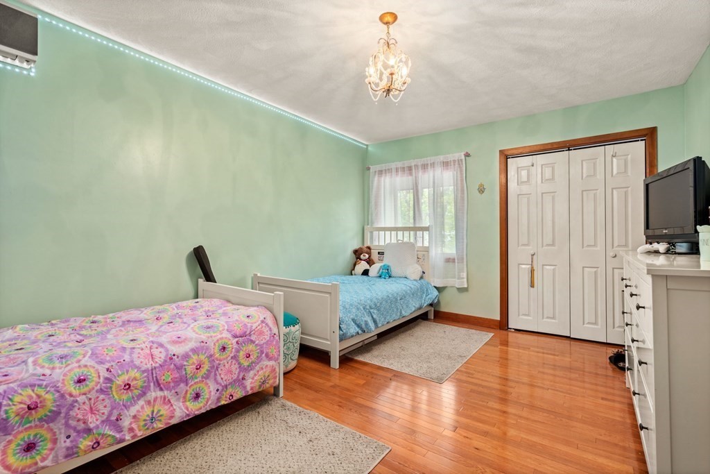 3 Macone Circle Stoneham, MA 02180 - Photo 17 of 26 a bedroom with a bed and flat tv screen on the dresser