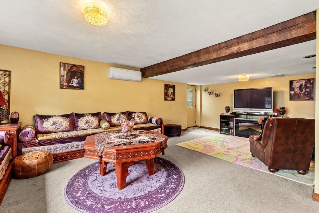 3 Macone Circle Stoneham, MA 02180 - Photo 22 of 26 a living room with furniture and a flat screen tv