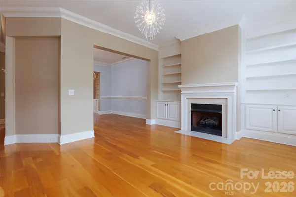 a view of an empty room with a fireplace and a window