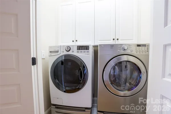 a view of a hallway with washer and dryer