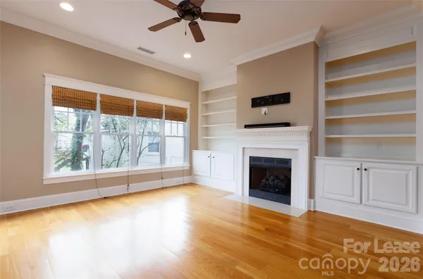 a view of an empty room with a fireplace and a window