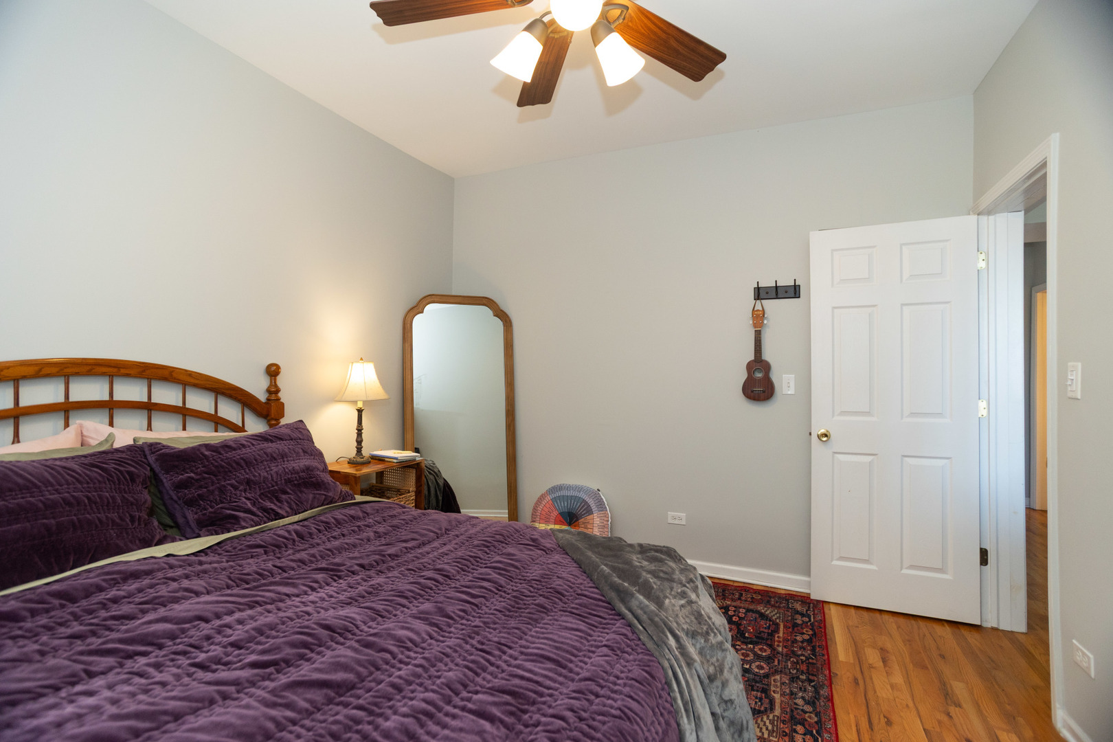 2709 West Lawrence Avenue, Unit 3 Chicago, IL 60625 - Photo 13 of 16 a bedroom with a bed and wooden floor