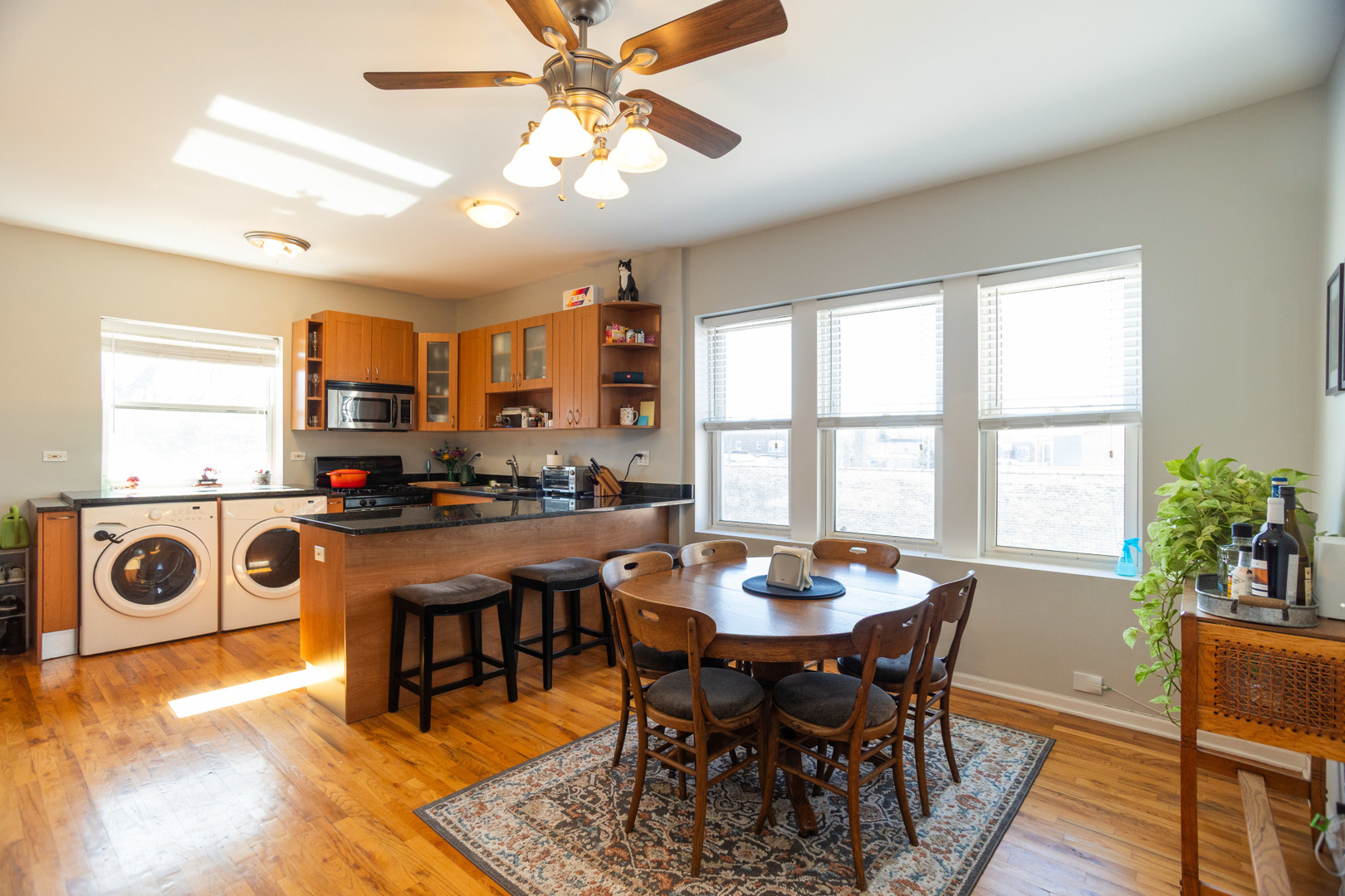 2709 West Lawrence Avenue, Unit 3 Chicago, IL 60625 - Photo 5 of 16 a view of a dining room with furniture window and wooden floor