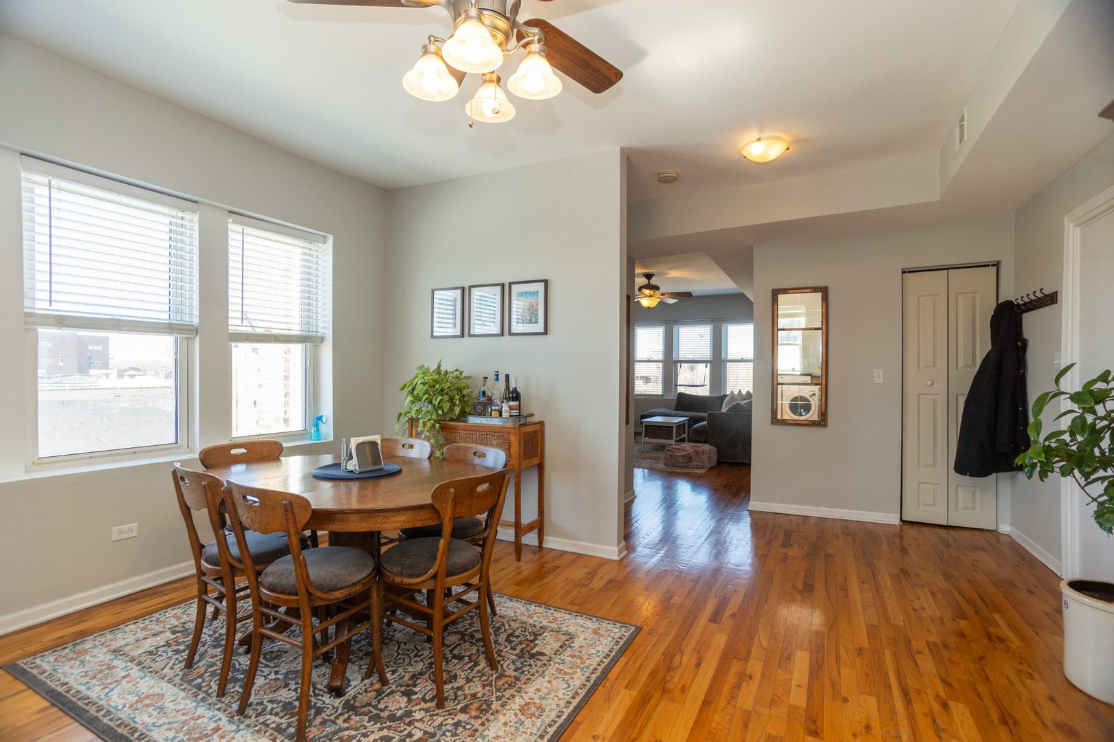 2709 West Lawrence Avenue, Unit 3 Chicago, IL 60625 - Photo 7 of 16 a view of a dining room with furniture wooden floor and a chandelier
