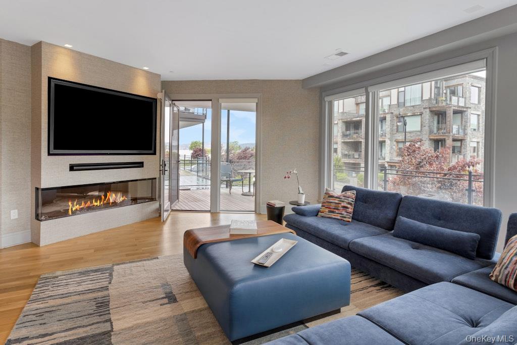18 Rivers Edge Drive, Unit 211 Tarrytown, NY 10591 - Photo 7 of 30 a living room with furniture and a flat screen tv