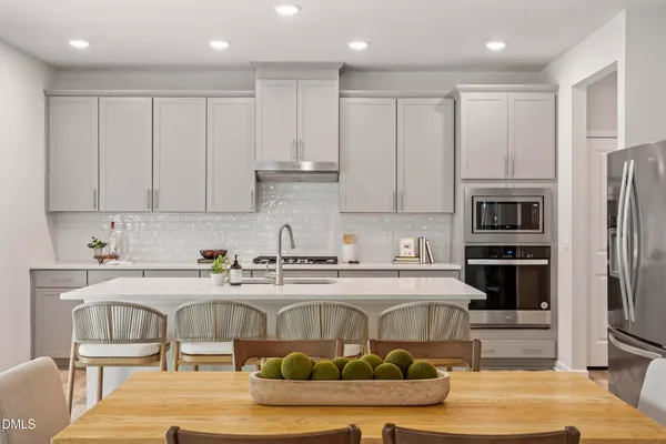a kitchen with stainless steel appliances granite countertop a refrigerator sink and cabinets