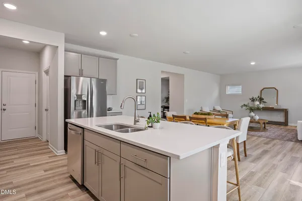 a kitchen with stainless steel appliances a sink stove and refrigerator