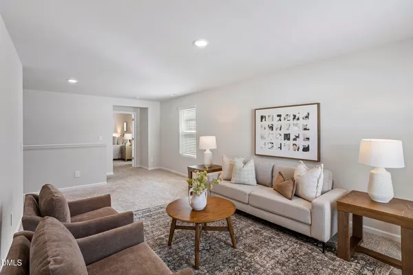 a living room with furniture and a lamp