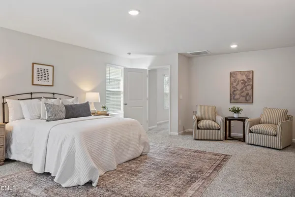 a bedroom with a bed and a couch