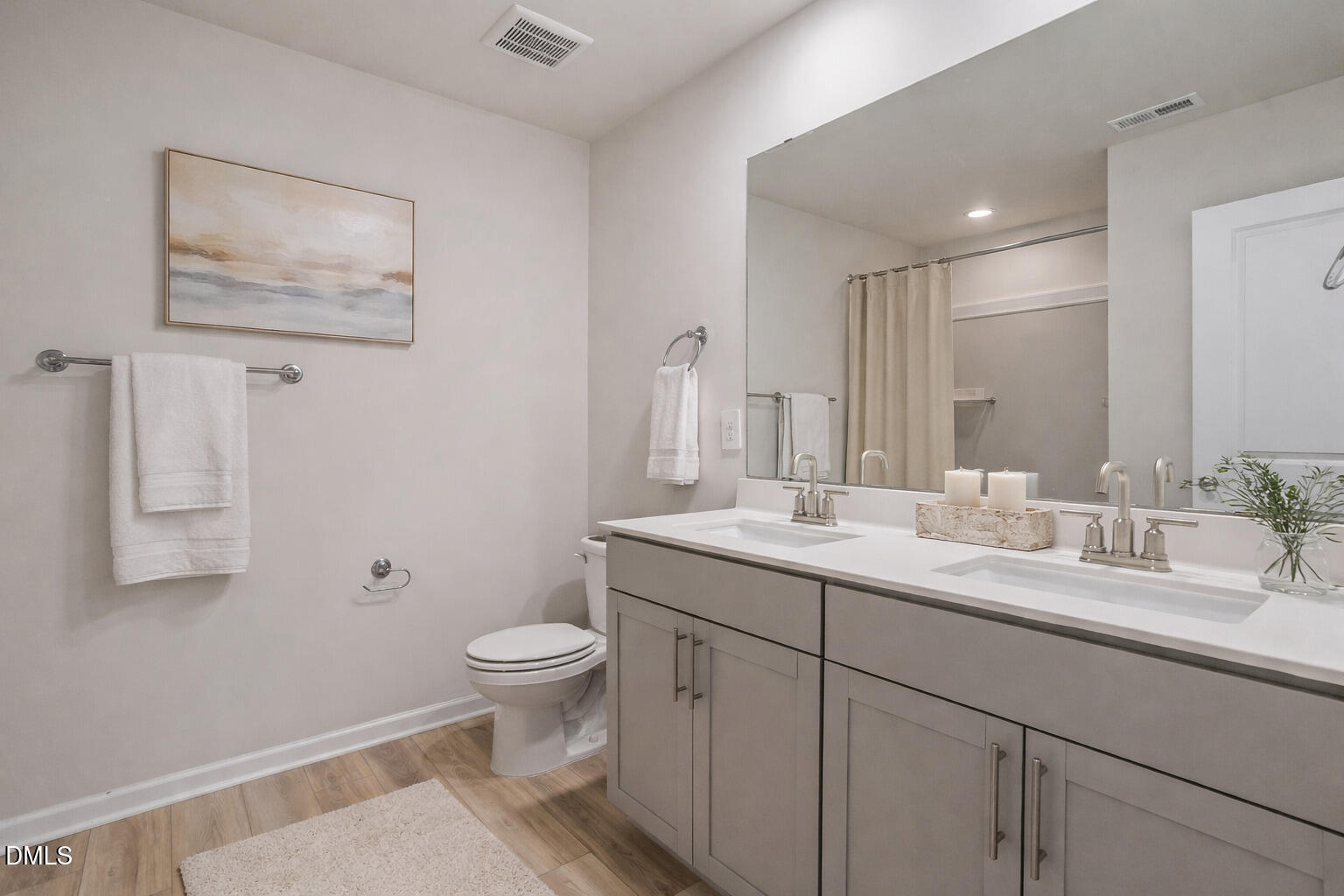 1105 Umstead Grv Way Durham, NC 27712 - Photo 32 of 38 a bathroom with a granite countertop sink a toilet and a mirror