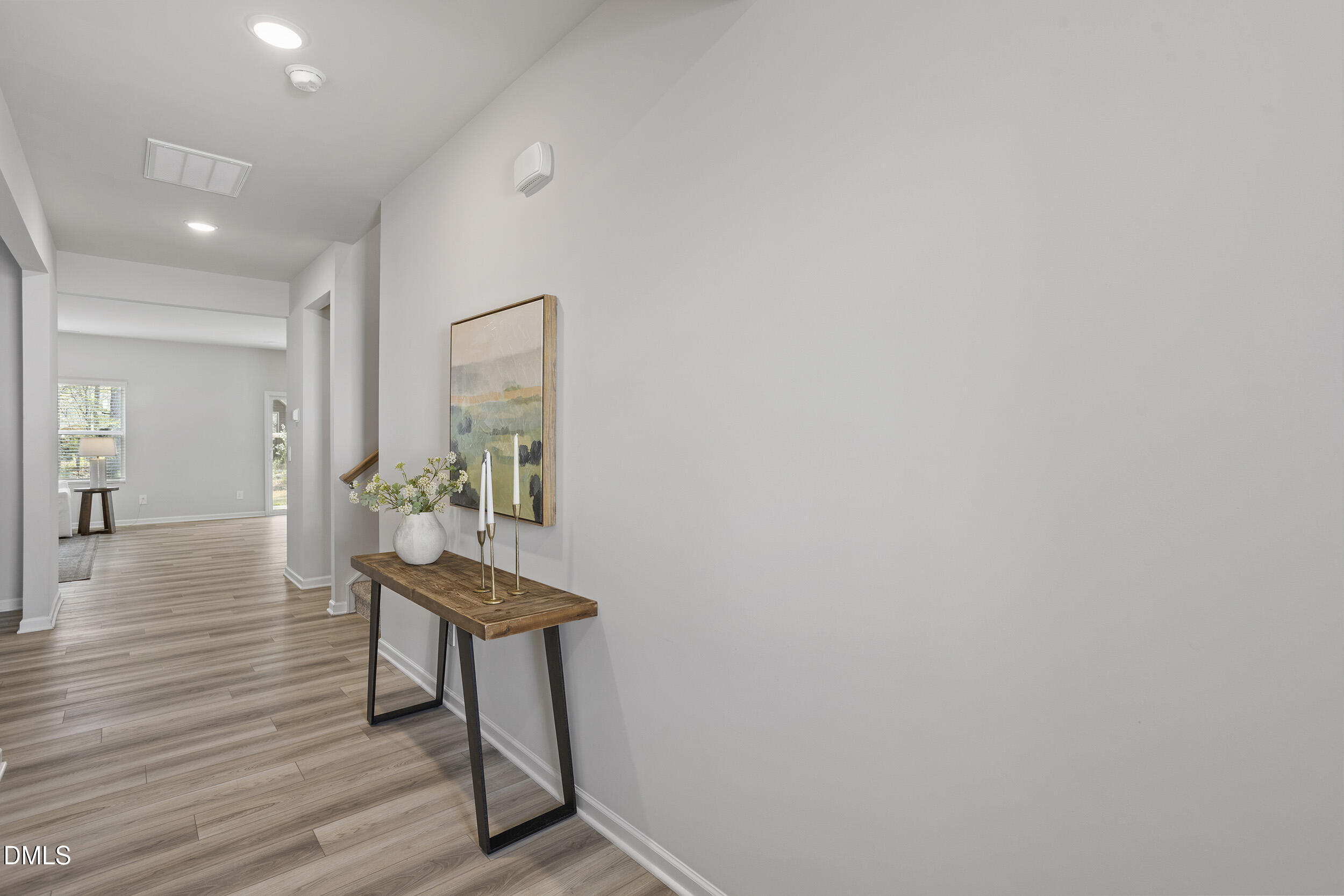 1105 Umstead Grv Way Durham, NC 27712 - Photo 5 of 38 a hallway with wooden floor and furniture