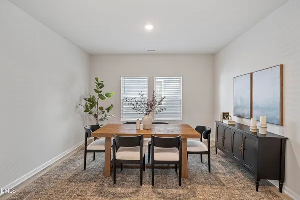 a dining room with furniture and window