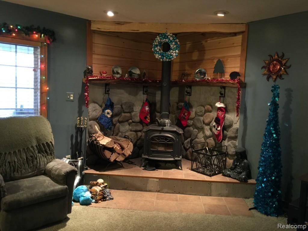 7305 Crofoot Road Fowlerville, MI 48836 - Photo 11 of 36 Cozy, custom corner with wood burner