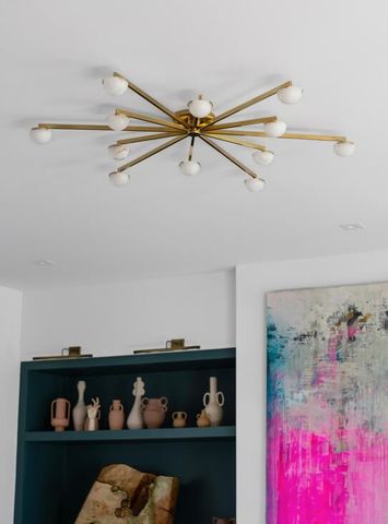 a view of a hallway with wooden floor and cabinet