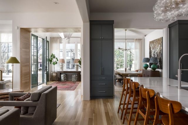 a bathroom with a double vanity sink a large mirror and a bathtub
