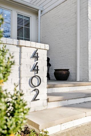 a view of living room filled with furniture and a potted plant