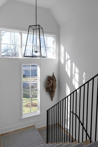 a living room with fireplace furniture and a floor to ceiling window