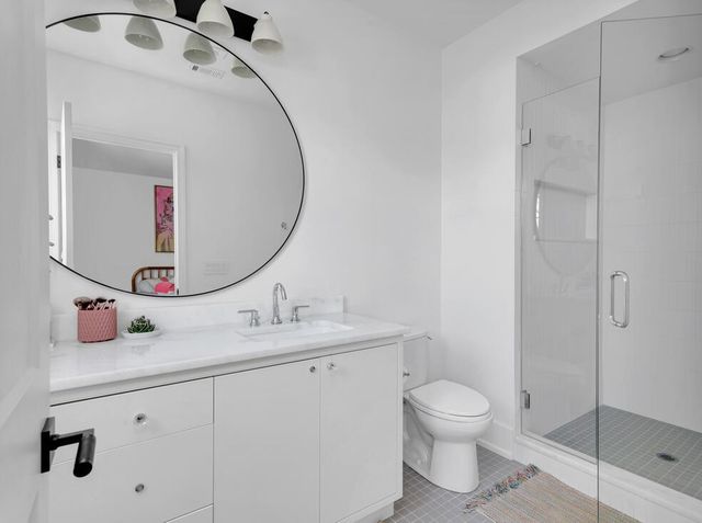 a bedroom with bed and a chandelier