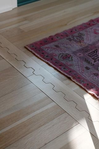 a living room with furniture fireplace and a large window