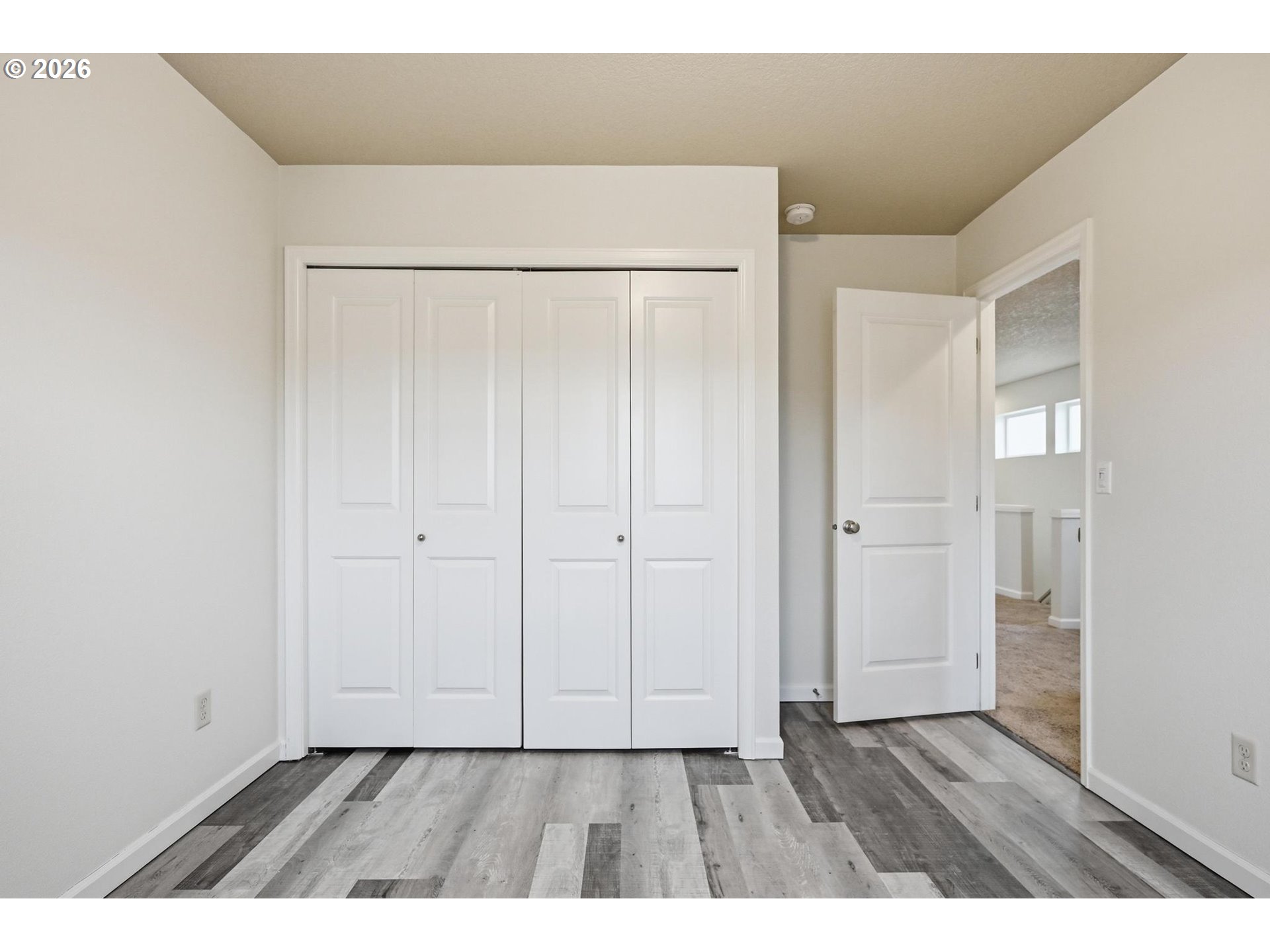 20881 Southwest Edgemont Street Beaverton, OR 97003 - Photo 22 of 39 a view of an empty room with wooden floor