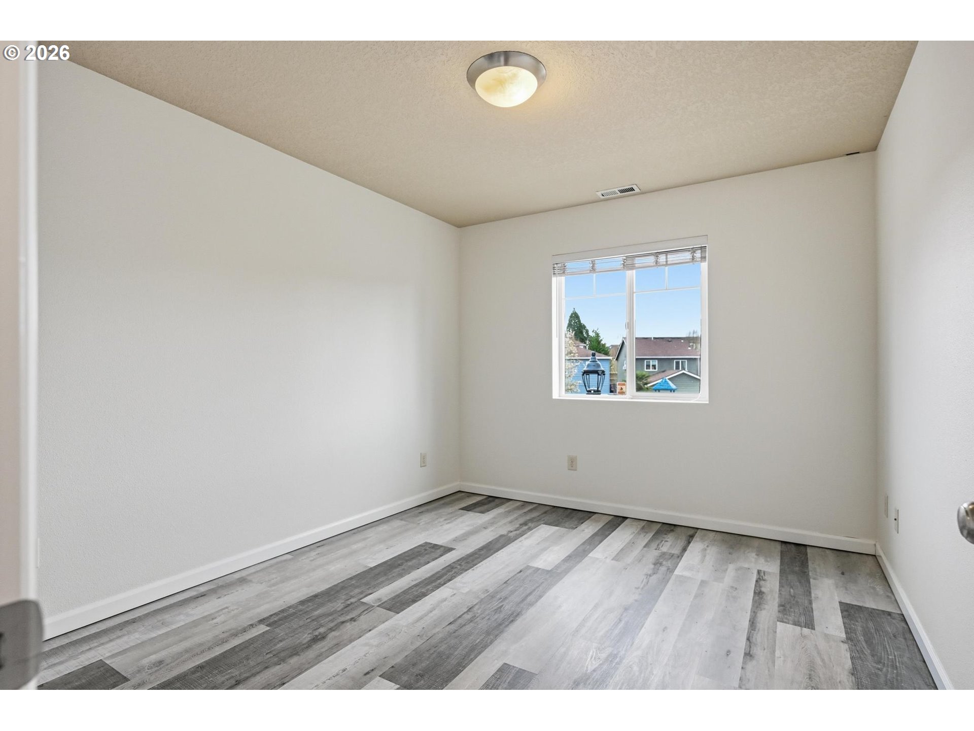 20881 Southwest Edgemont Street Beaverton, OR 97003 - Photo 23 of 39 an empty room with wooden floor and windows