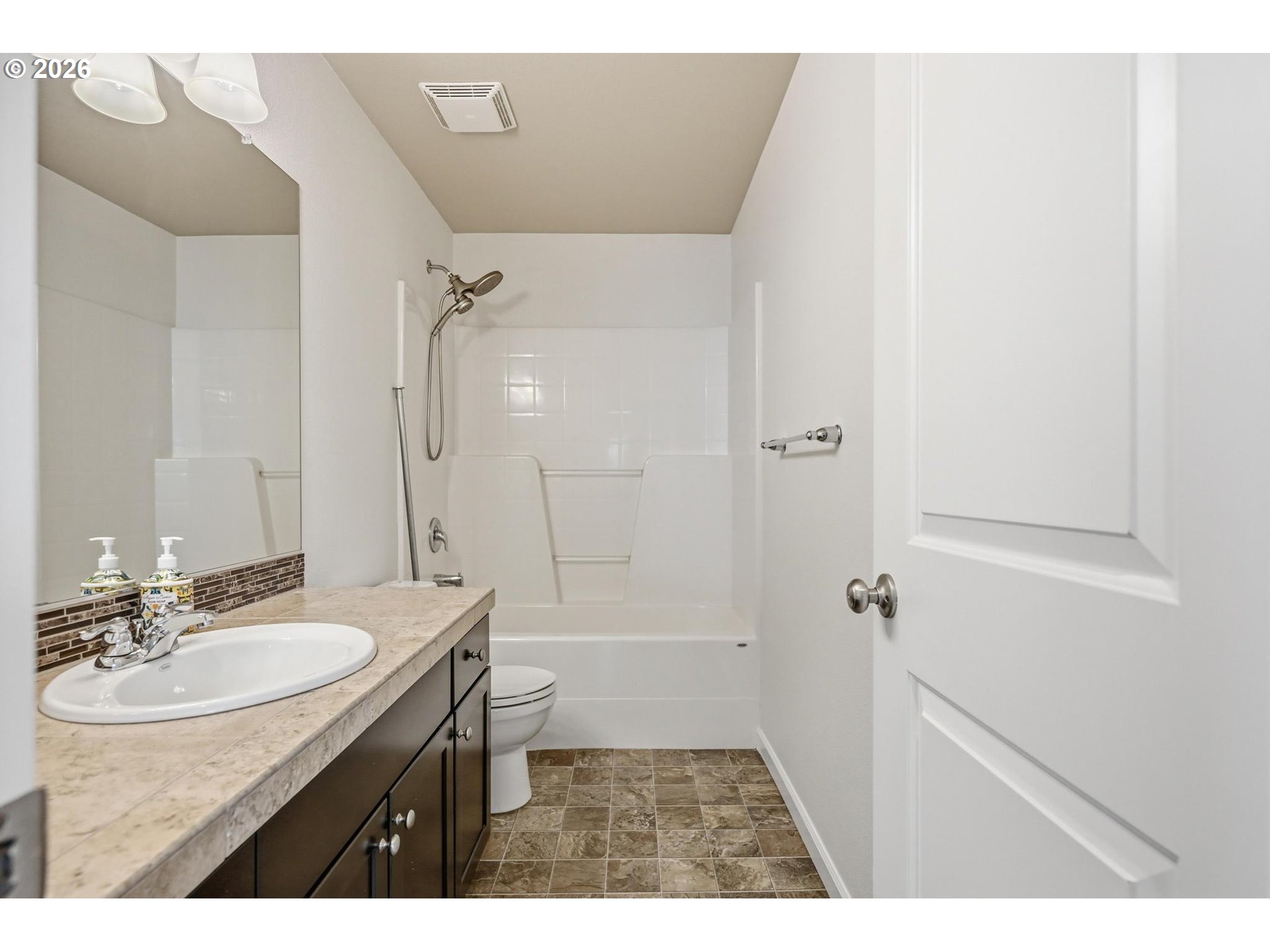 20881 Southwest Edgemont Street Beaverton, OR 97003 - Photo 25 of 39 a bathroom with a sink a toilet a mirror and shower