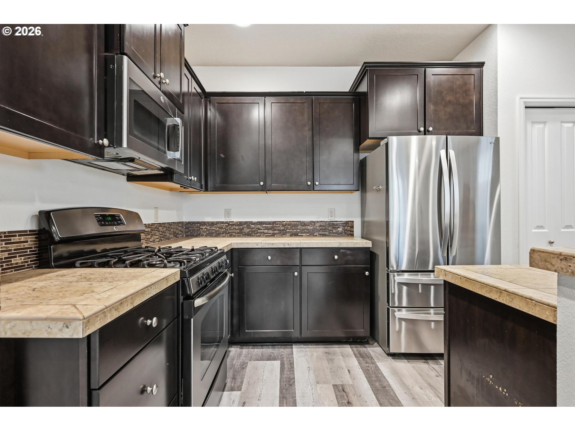 20881 Southwest Edgemont Street Beaverton, OR 97003 - Photo 5 of 39 a kitchen with stainless steel appliances granite countertop a stove a sink and a refrigerator