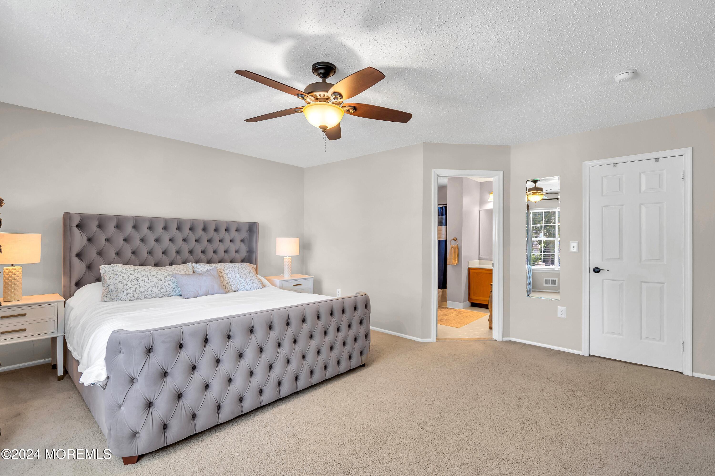 161 Old Orchard Road Toms River, NJ 08755 - Photo 18 of 32 a bedroom with a bed and a chandelier