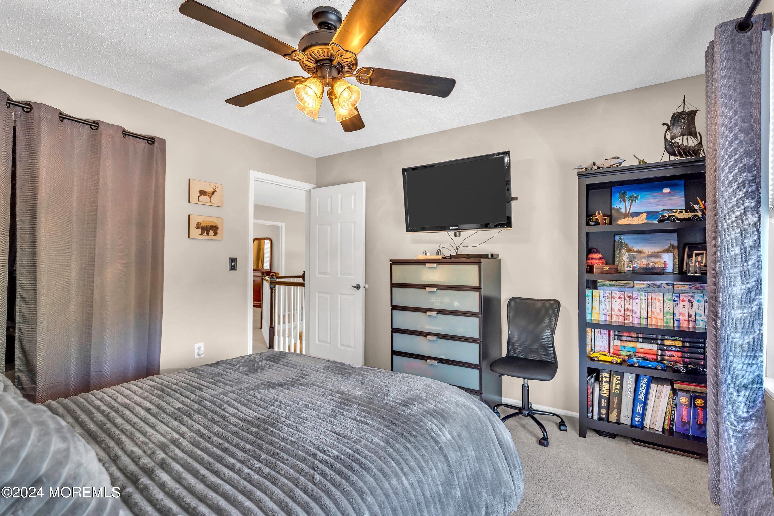161 Old Orchard Road Toms River, NJ 08755 - Photo 20 of 32 a bedroom with a bed and a flat screen tv
