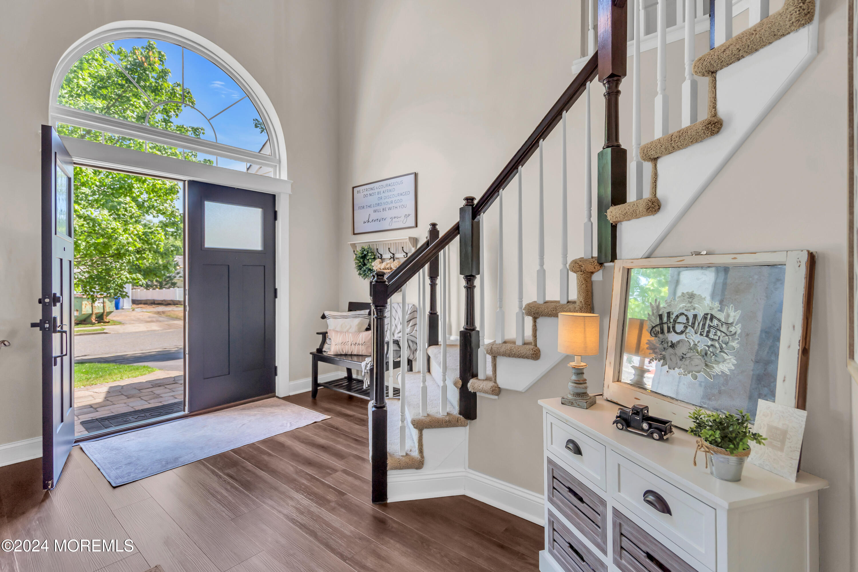 161 Old Orchard Road Toms River, NJ 08755 - Photo 2 of 32 a view of an entryway with wooden floor windows and a chandelier