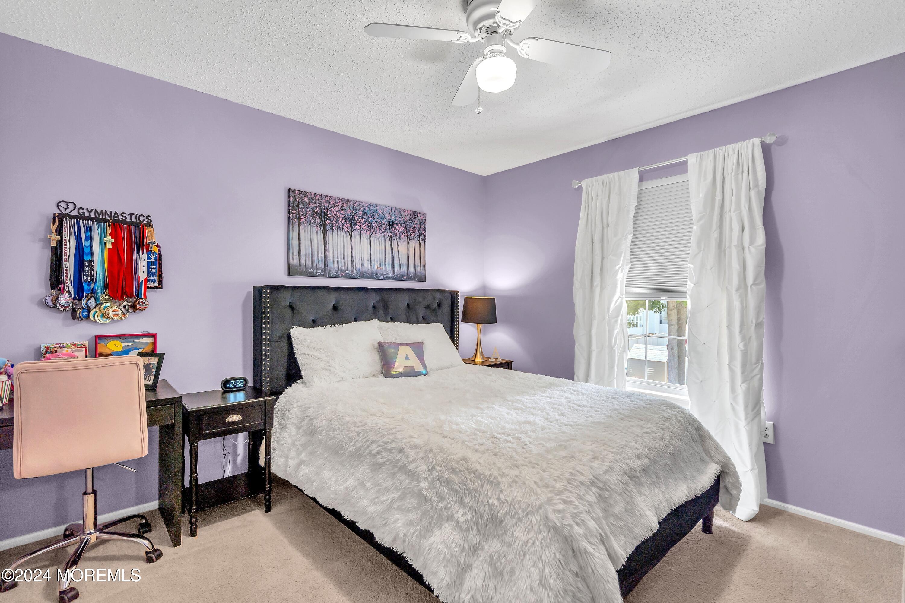 161 Old Orchard Road Toms River, NJ 08755 - Photo 22 of 32 a bedroom with a bed and a chandelier