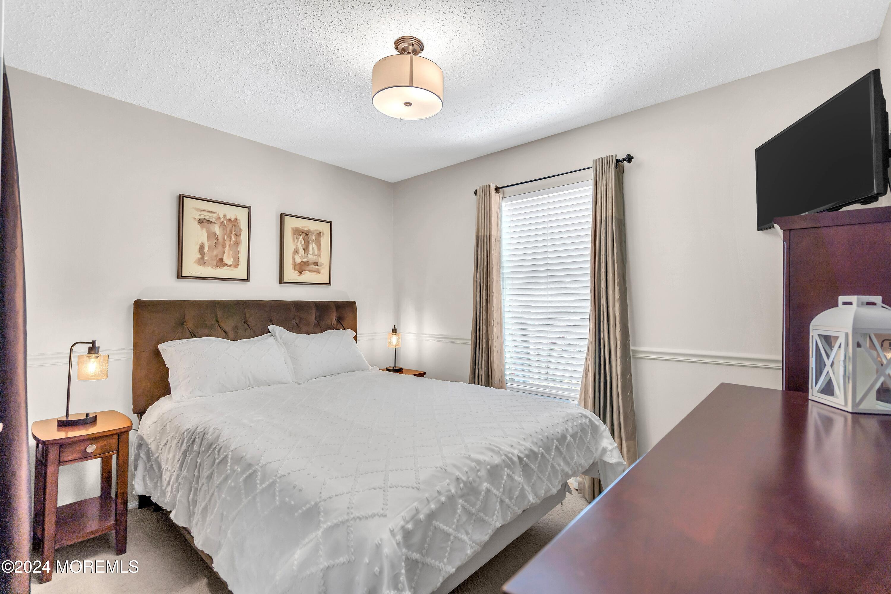 161 Old Orchard Road Toms River, NJ 08755 - Photo 25 of 32 a bedroom with a bed and a flat screen tv