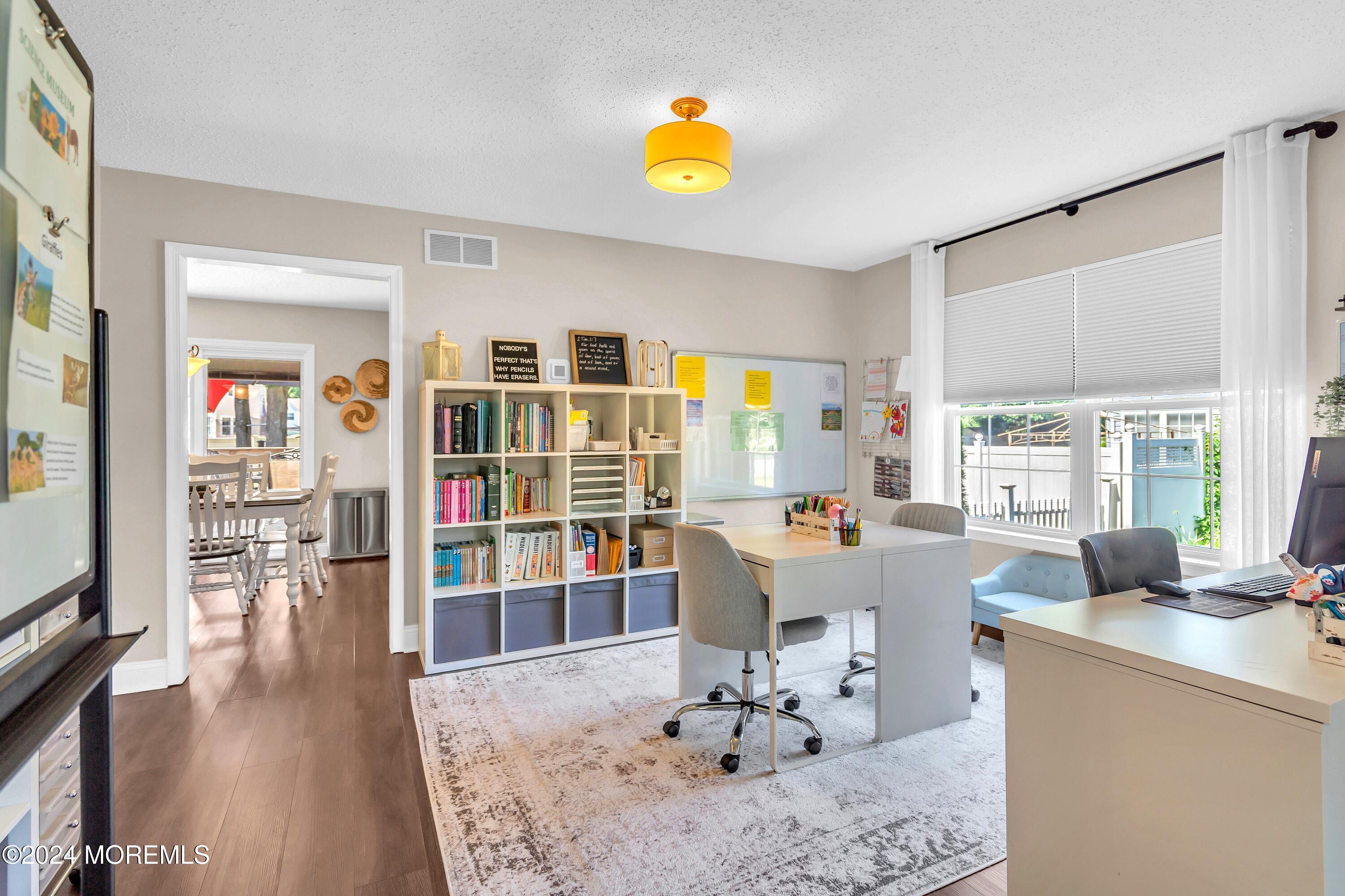 161 Old Orchard Road Toms River, NJ 08755 - Photo 6 of 32 a living room with furniture a rug and a bookshelf