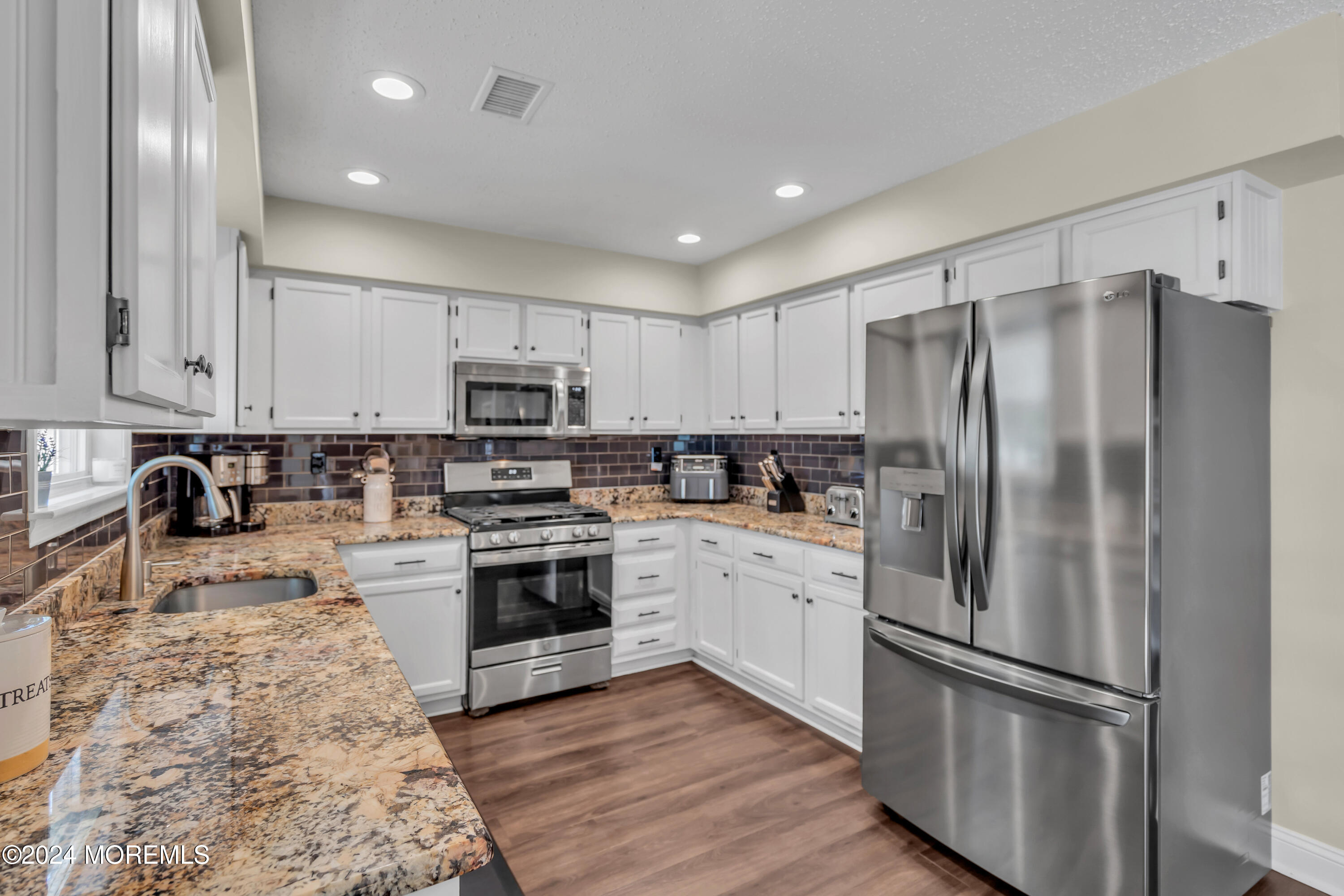 161 Old Orchard Road Toms River, NJ 08755 - Photo 9 of 32 a kitchen with granite countertop stainless steel appliances and wooden cabinets