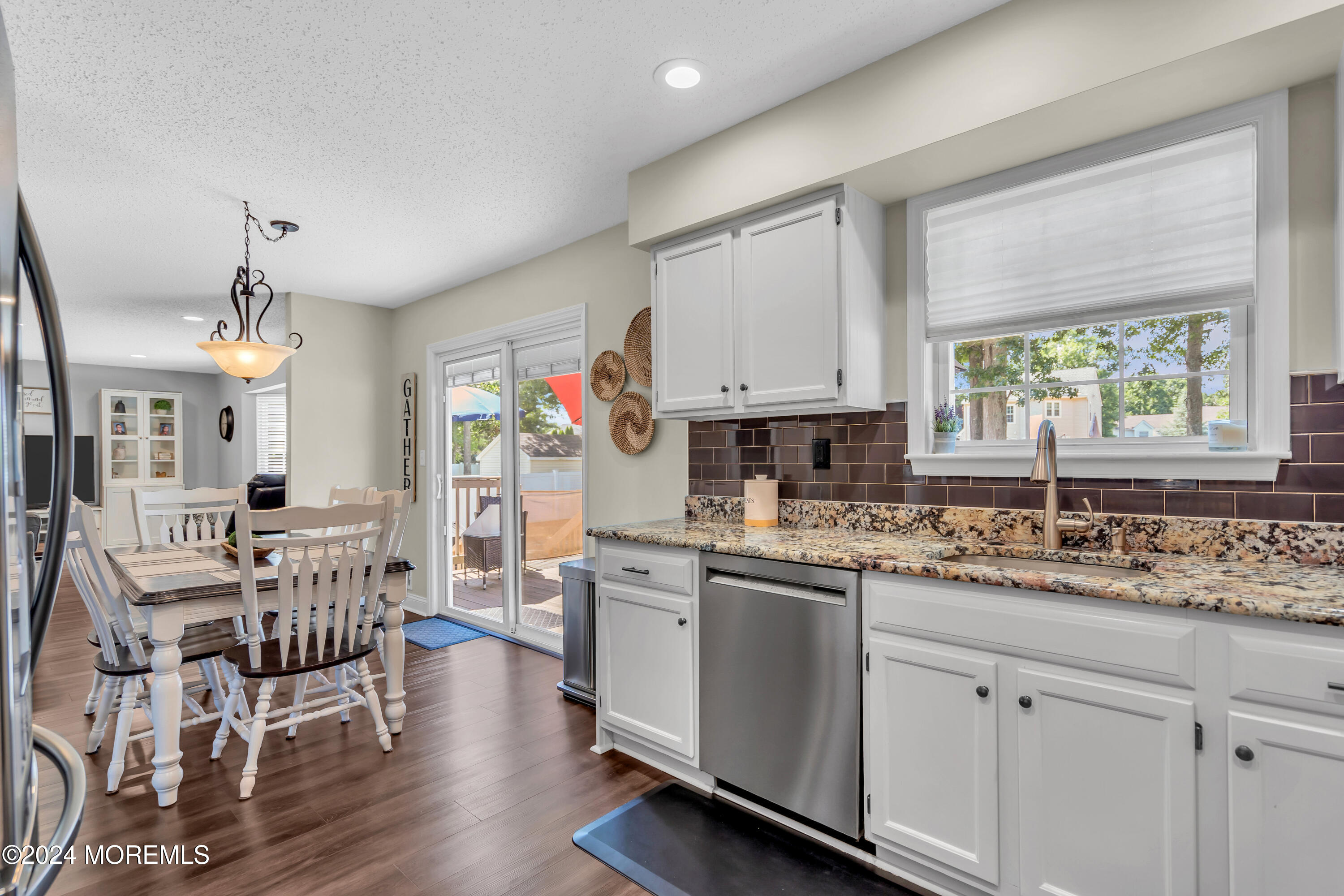 161 Old Orchard Road Toms River, NJ 08755 - Photo 10 of 32 a kitchen with stainless steel appliances white cabinets and wooden floors