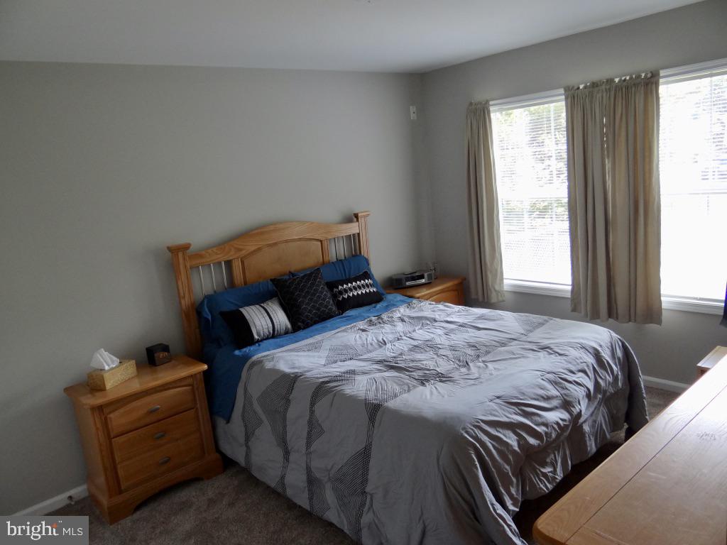 126 Green Street Mount Holly, NJ 08060 - Photo 12 of 41 a bed sitting in a bedroom next to a window