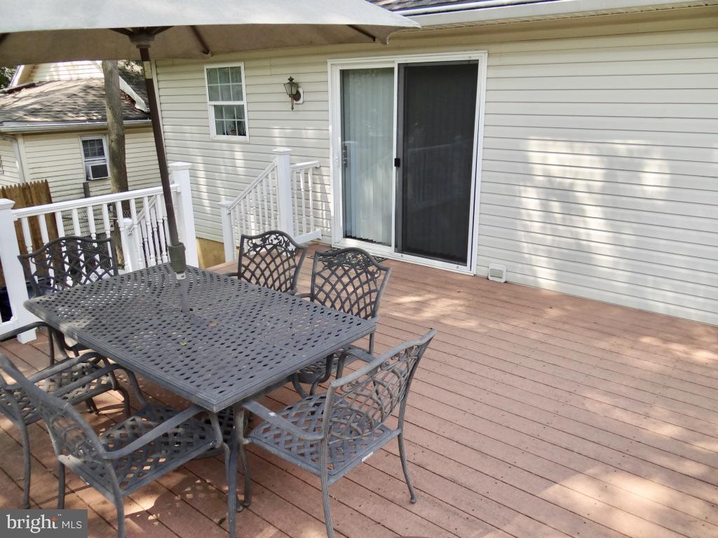 126 Green Street Mount Holly, NJ 08060 - Photo 35 of 41 a roof deck with a dining table and chairs with wooden floor