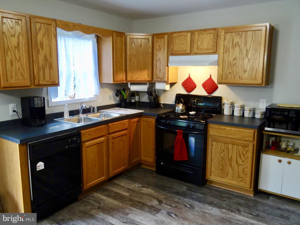 126 Green Street Mount Holly, NJ 08060 - Photo 8 of 41 a kitchen with stainless steel appliances granite countertop a stove a sink dishwasher and a microwave oven with cabinets