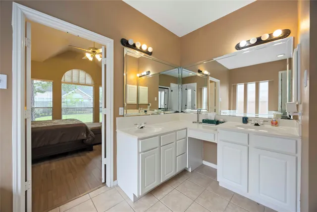 a large bathroom with a large mirror vanity and sink