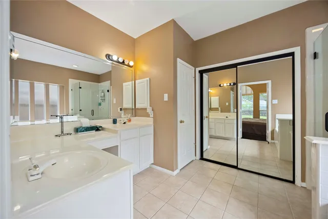 a large bathroom with a tub a sink and mirror