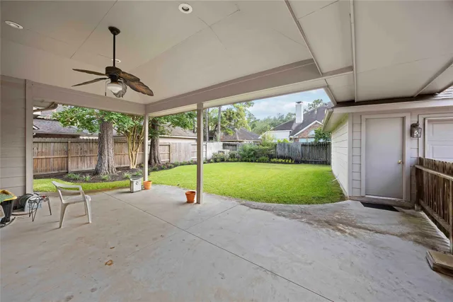 a view of a backyard with garden and patio
