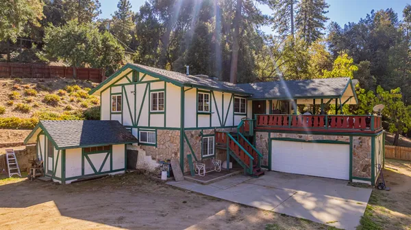a view of a house with a wooden fence