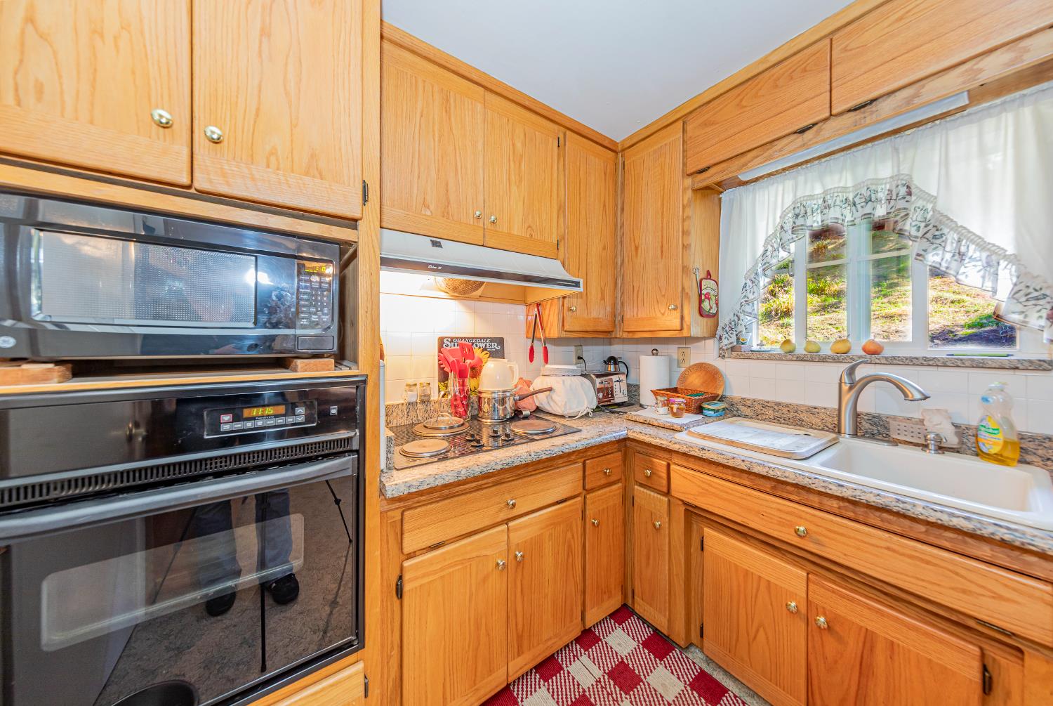 42585 Buckeye Road Oakhurst, CA 93644 - Photo 13 of 55 a kitchen with stainless steel appliances a stove sink and cabinets