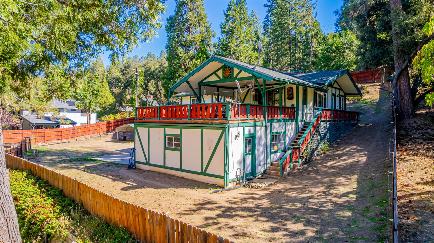 42585 Buckeye Road Oakhurst, CA 93644 - Photo 48 of 55 a view of a wooden deck with large trees and wooden fence