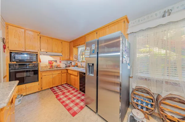a kitchen with a refrigerator and a sink