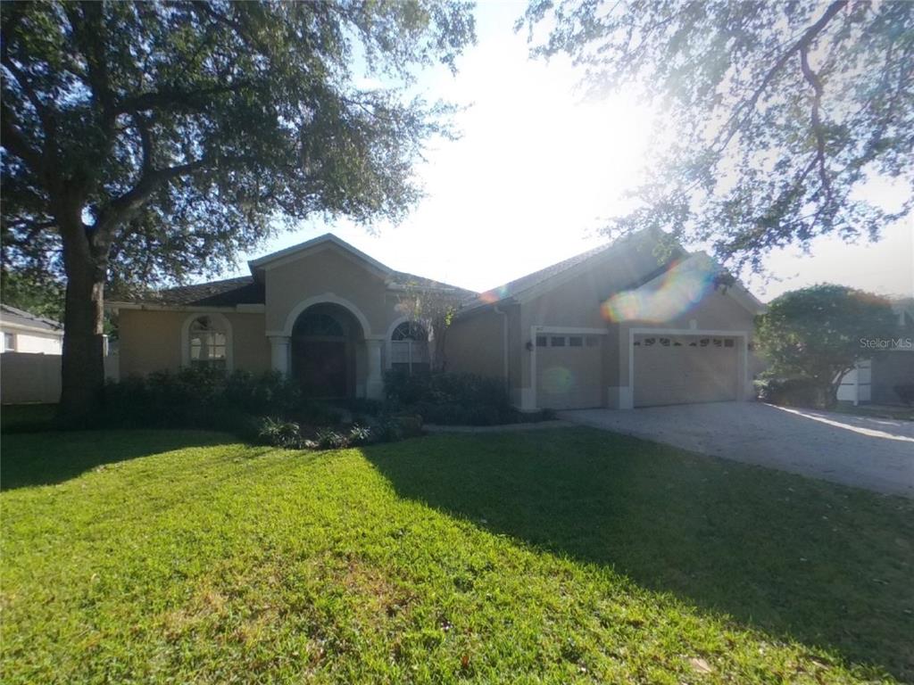 Undisclosed Address Valrico, FL 33596 - Photo 1 of 16 a house view with a garden space