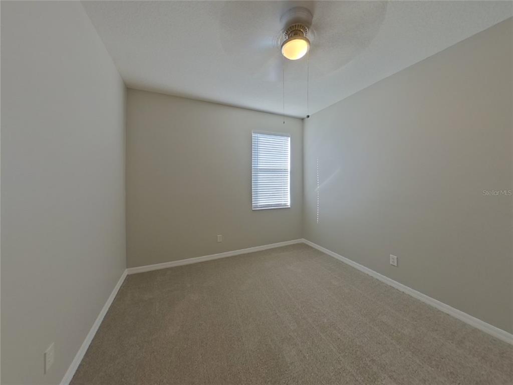 Undisclosed Address Valrico, FL 33596 - Photo 11 of 16 a view of an empty room with a window