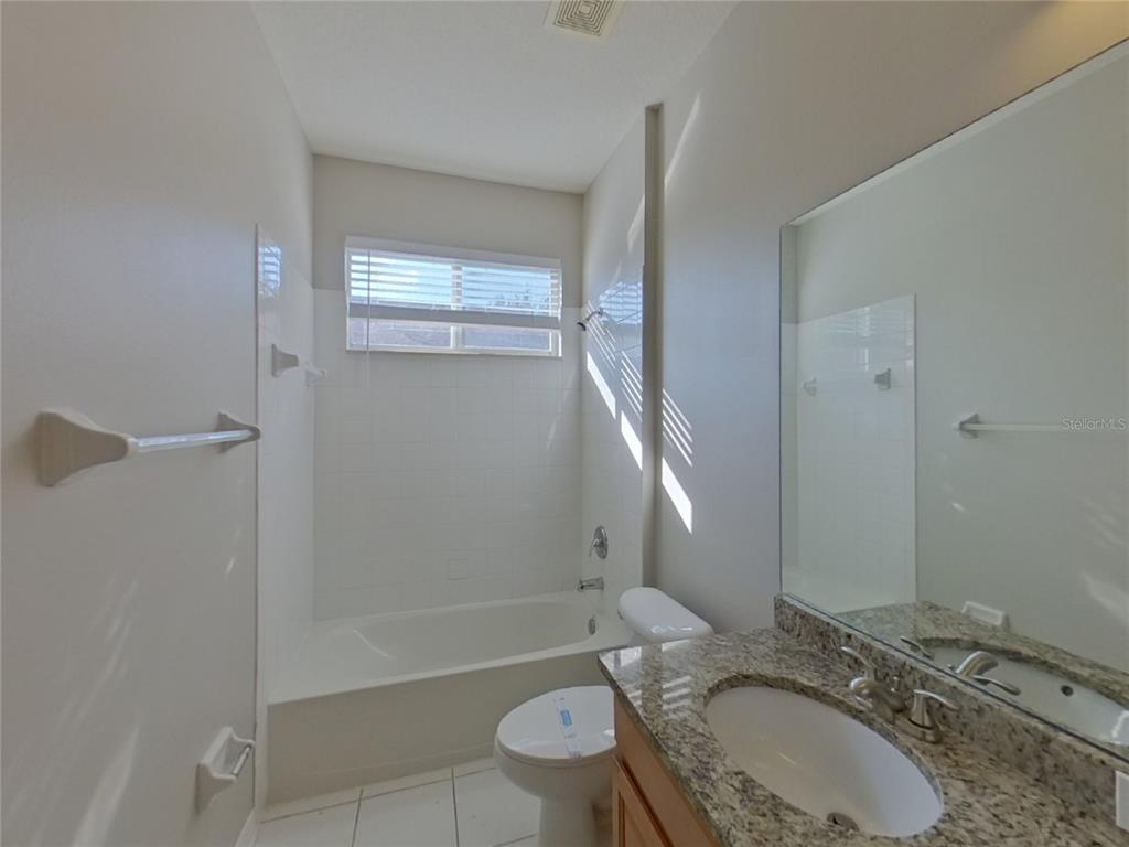 Undisclosed Address Valrico, FL 33596 - Photo 13 of 16 a bathroom with a granite countertop sink toilet and shower