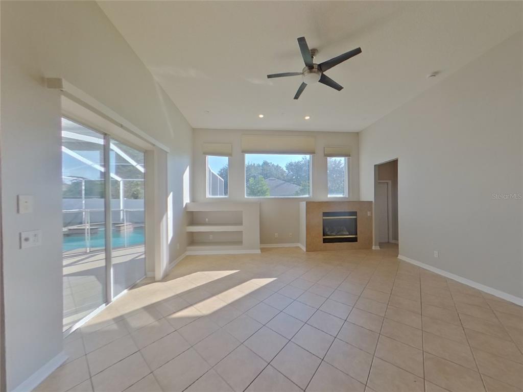 Undisclosed Address Valrico, FL 33596 - Photo 3 of 16 a view of a livingroom with a ceiling fan a kitchen view and a window
