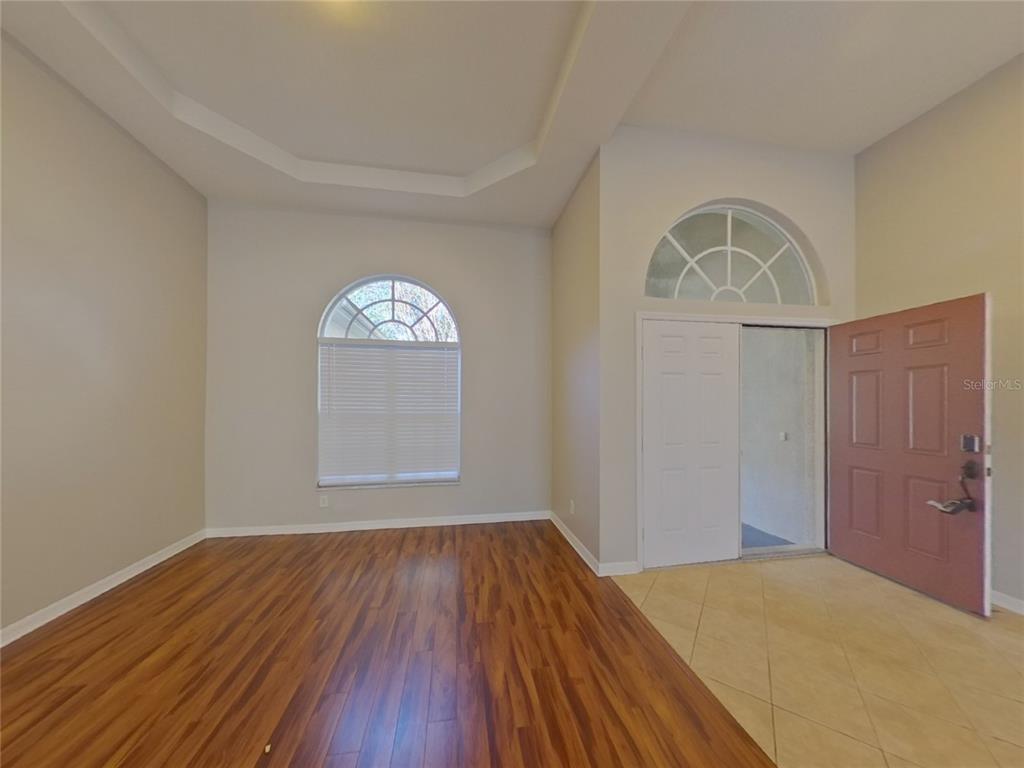Undisclosed Address Valrico, FL 33596 - Photo 4 of 16 a view of empty room with wooden floor and fan